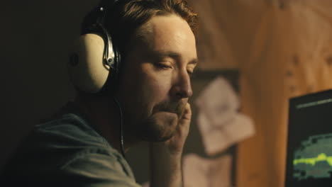 man listening intently to headphones