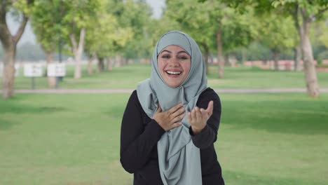 Happy-Muslim-woman-laughing-on-someone-in-park