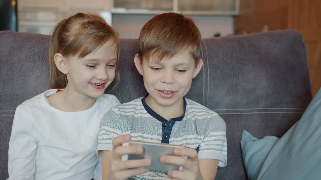 Children using a smartphone together