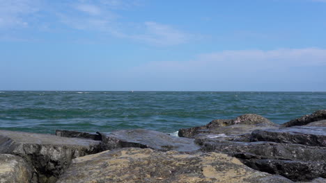 the waves from the ocean breaking over the rocks on the shore