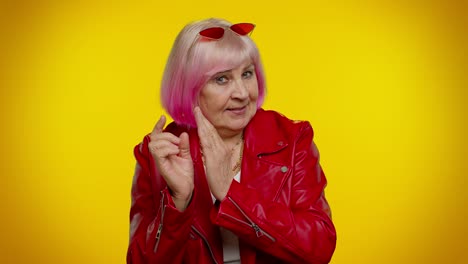 sneaky mature grandmother woman scheming, thinking over tricky plan with cunning face, joke prank