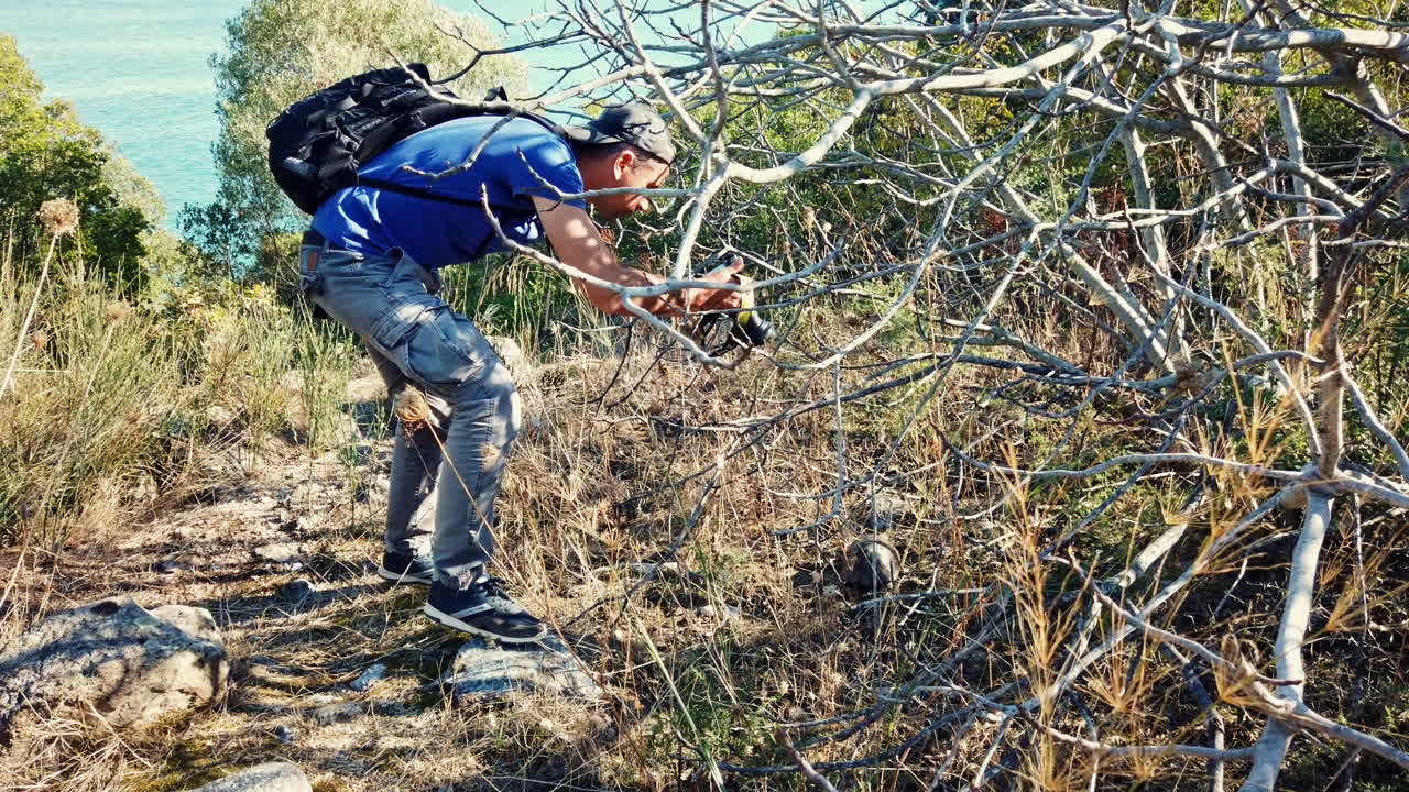 Photorgrapher shooting a turtle in the nature on the Aegean sea coast in Greece