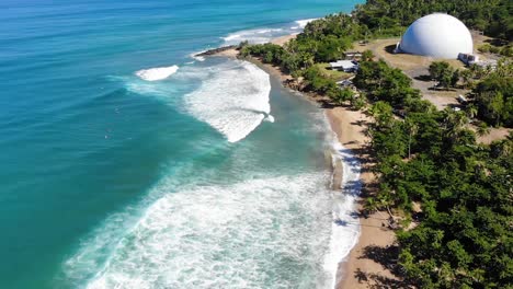 aerial view of surfers waiting for the waves in domes beach