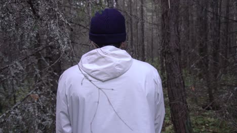 man walking through a forest