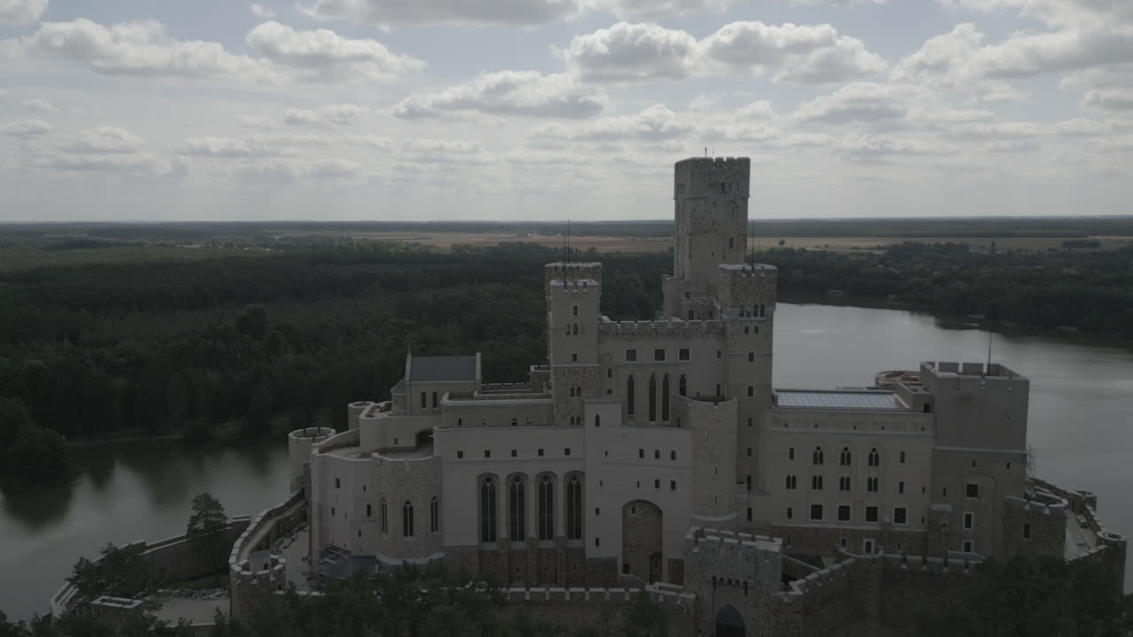 Stobnica Castle in the forest and near the lake (drone-front view)
