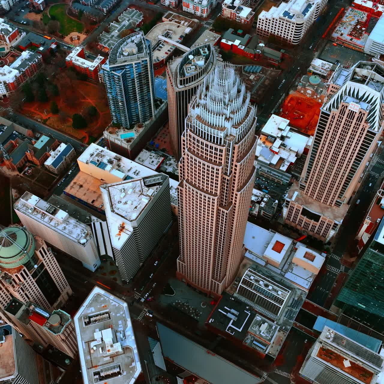 Drone footage high above the stunning skyscrapers of Charlotte, North Carolina, USA. Approaching the tops of high-rise buildings in city downtown.