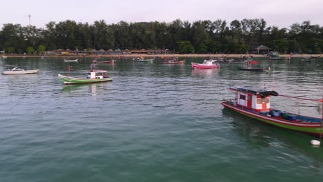 Drone-aerial-parallax-with-Thai-boats-around-tropical-blue-water