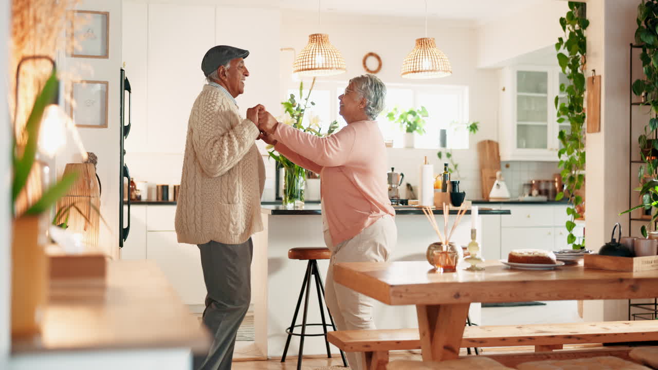 Senior couple dancing in the kitchen
