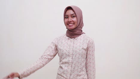 young confidence asian muslim woman standing while showing okay hand gesture