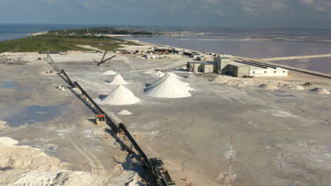 coastal saltern with mounds of dried salt and saltworks in yucatan