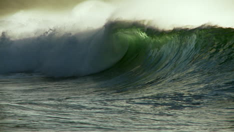 large waves crest and break in slow motion