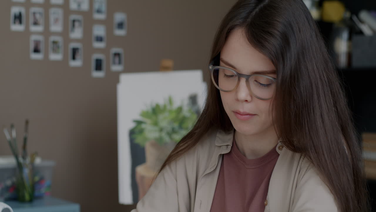Young Artist Concentrating on Artwork in Home Studio