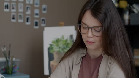 young artist concentrating on artwork in home studio