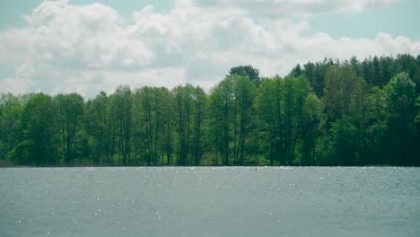 Midday-sun-glints-on-the-lake-water-surface