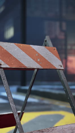 close-up of a weathered wooden barricade with orange and white stripes