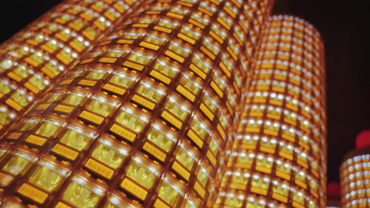 Many towers of golden Buddha statues glowing in individual illuminated niches at Ciyou Temple in Taiwan, symbolizing devotion, peace, and spiritual reverence in a sacred Buddhist space