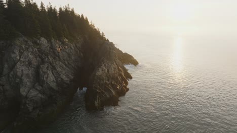 breathtaking view of golden sunrise glow illuminating jagged rocks on maine's bold coast