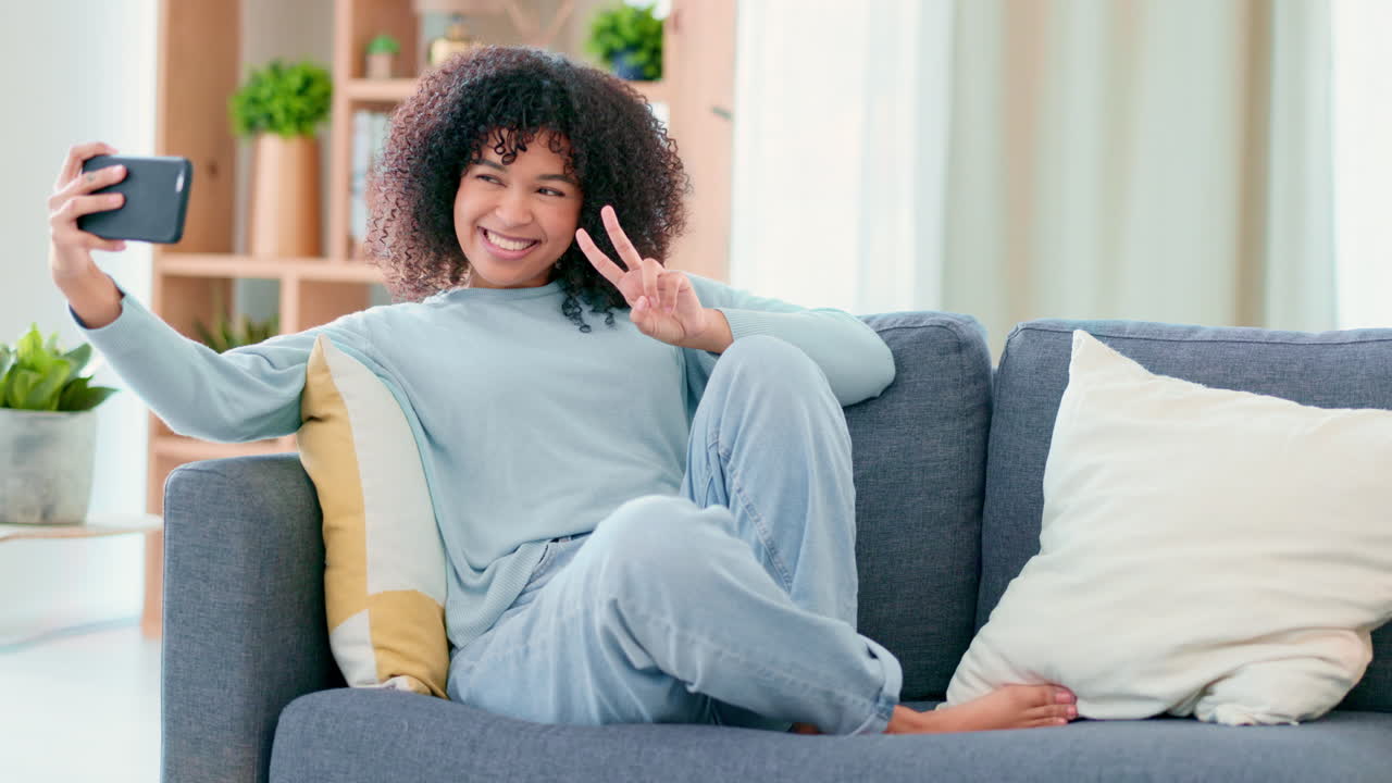 Young woman taking silly selfies with a camera