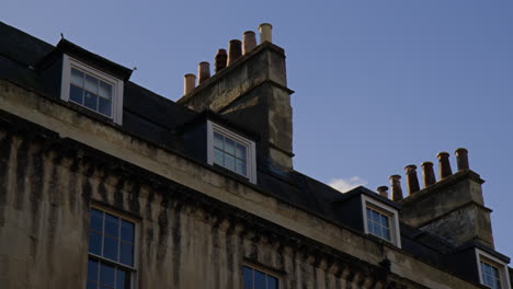 chimneys on roof of georgian townhouse in city of bath in uk