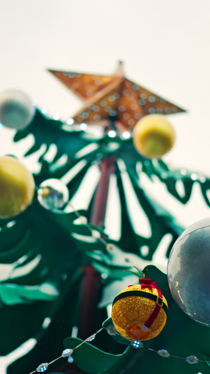 Close up of decorations on a metal rotating Christmas tree. Vertical