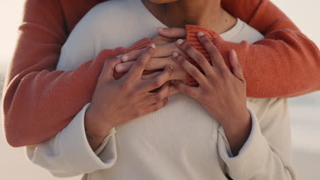 love, hands and lesbian couple hug at ocean