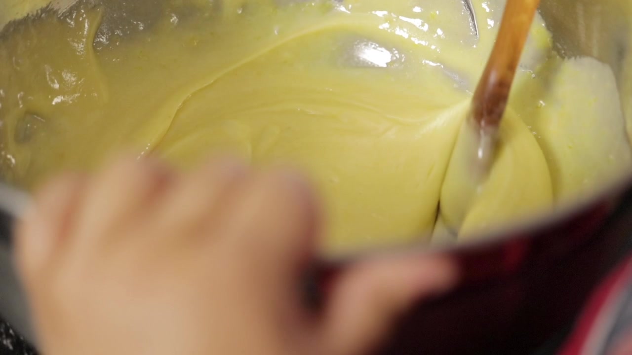 Children making a cake at home, close-up soft focus, slow motion