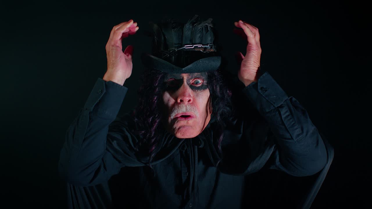 할로윈 위처 메이크업을 한 무서운 노인, 승리에 충격을 받아 놀라서 손을 들고