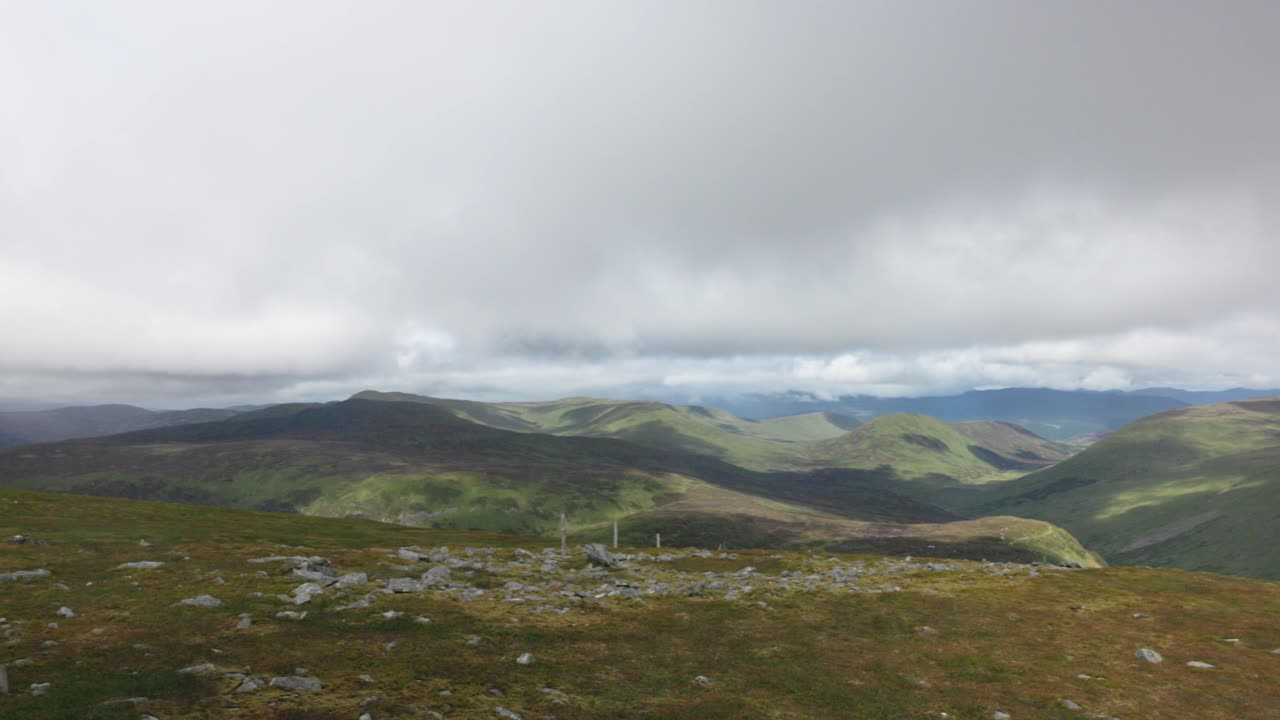 Slow panning shot of the various valleys on SHow from the summit of Ben Chonzie