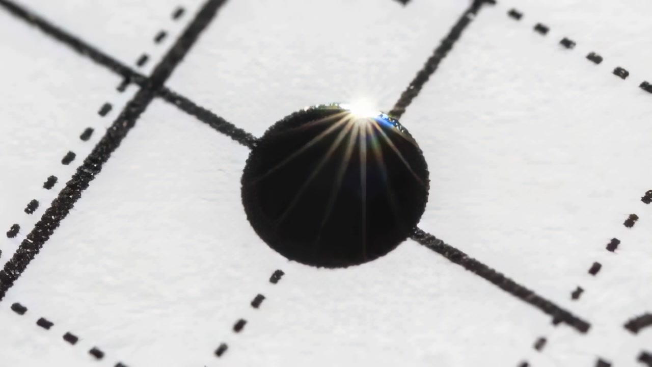 Shining point light creating shifting starburst along glossy black droplet rim on dashed grid paper