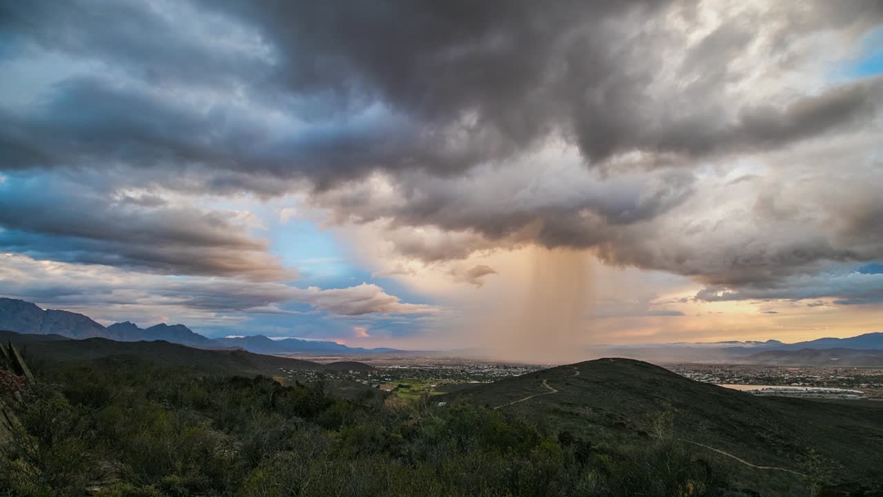 Microburst rain downpour over rural townscape, copyspace time-lapse
