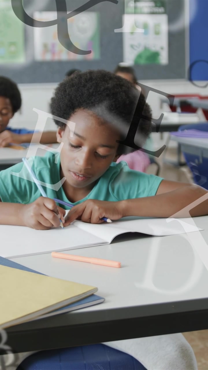 Vertical video: Boy writing in class, pencil touching paper and animating floating letters for work
