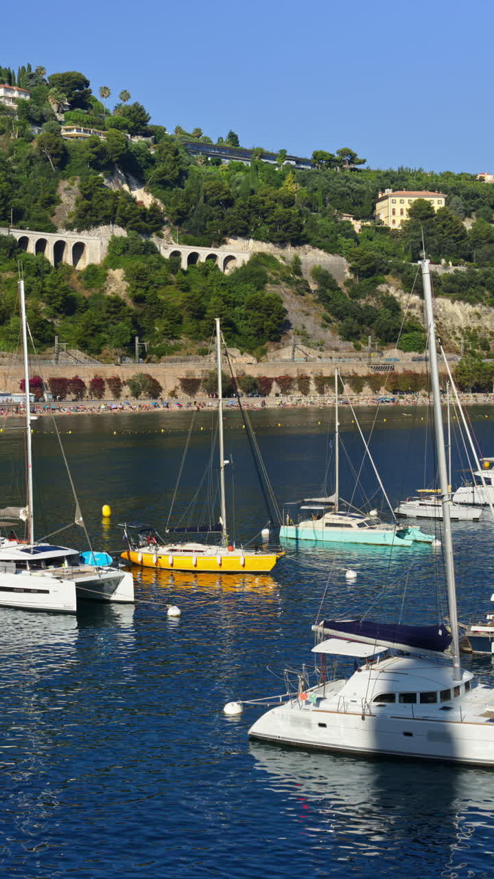 Boats docked in the local harbour in Villefranche sur Mer, France. Vertical