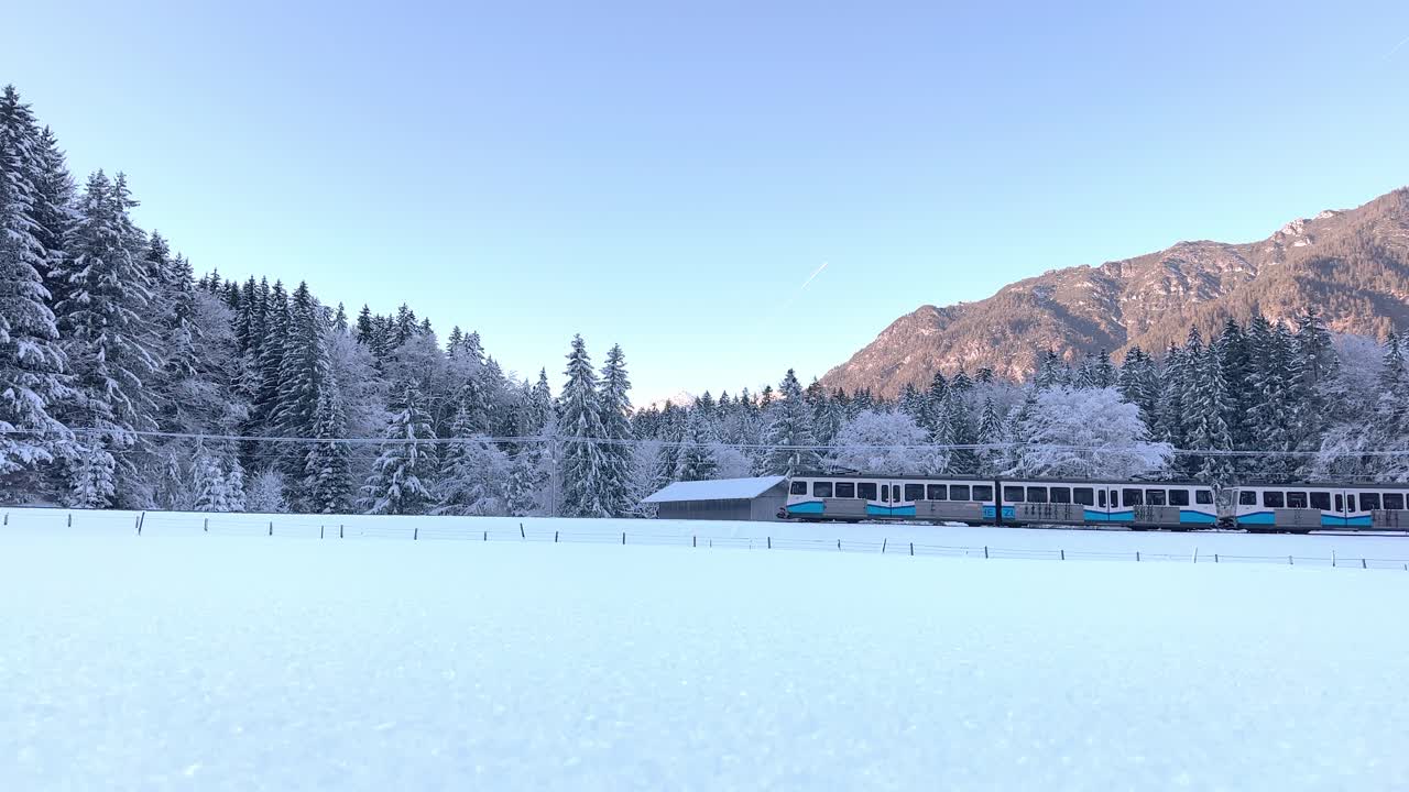 Narrow gauge train climbing a mountain with a steep slope in winter season
