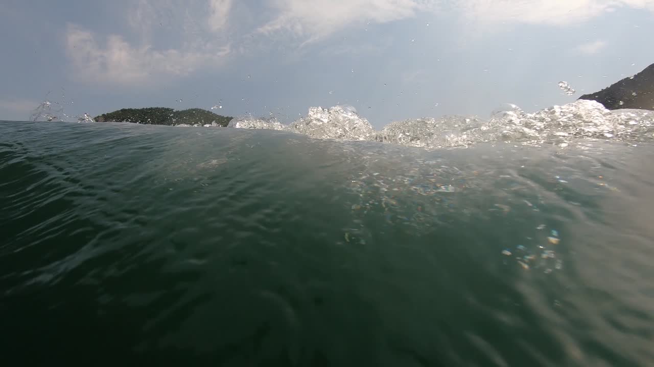 Speedboat waving lake water sailing alongside mountain slope on a sunny day, copy space