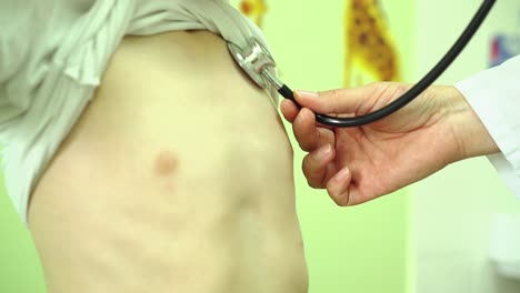 doctor examines the child with a phonendoscope