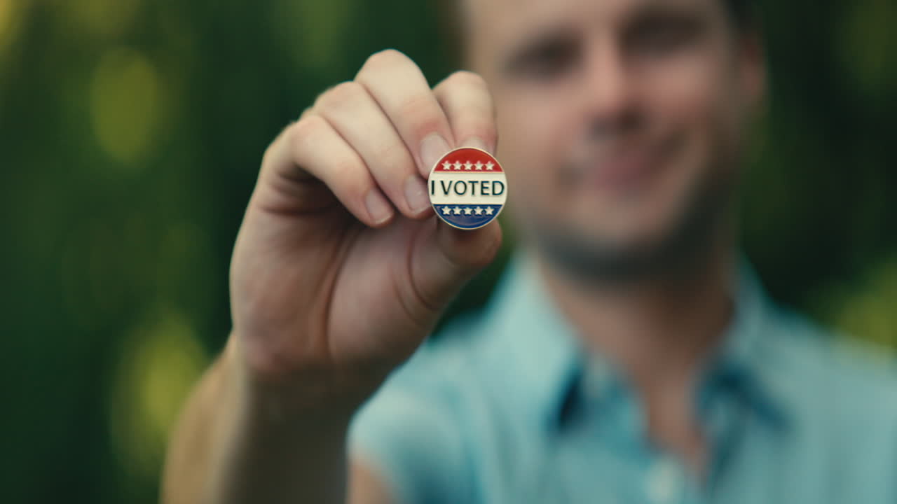 Man holding I Voted button