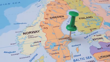 sweden - travel concept with green pushpin on the world map. the location point on the map points to stockholm the capital of the sweden.