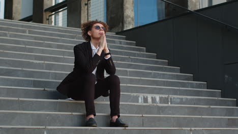 woman in a suit sitting on stairs