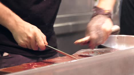 fishmonger chopping fresh eels