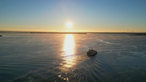 aerial ferry boat going into the sunset