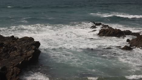 Hand-held-shot-of-small-waves-breaking-onto-Little-Fistral-Beach