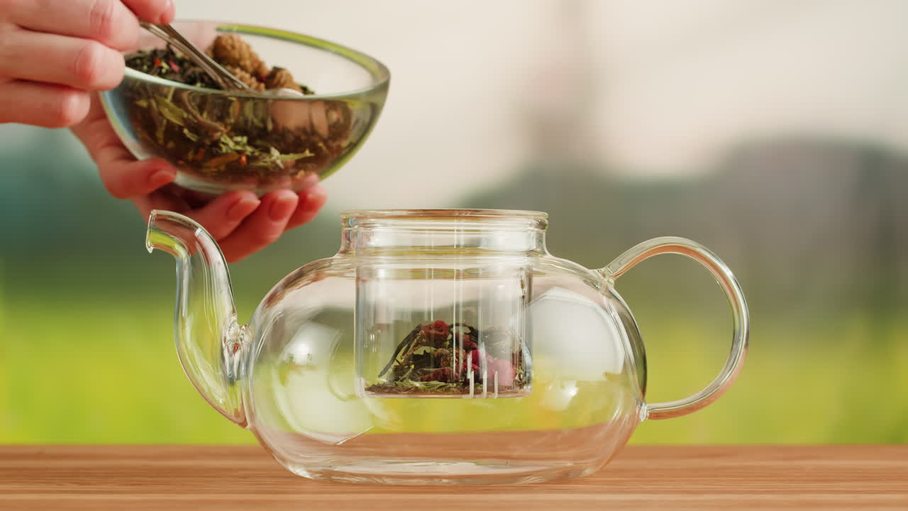 Preparing Herbal Tea in a Glass Teapot