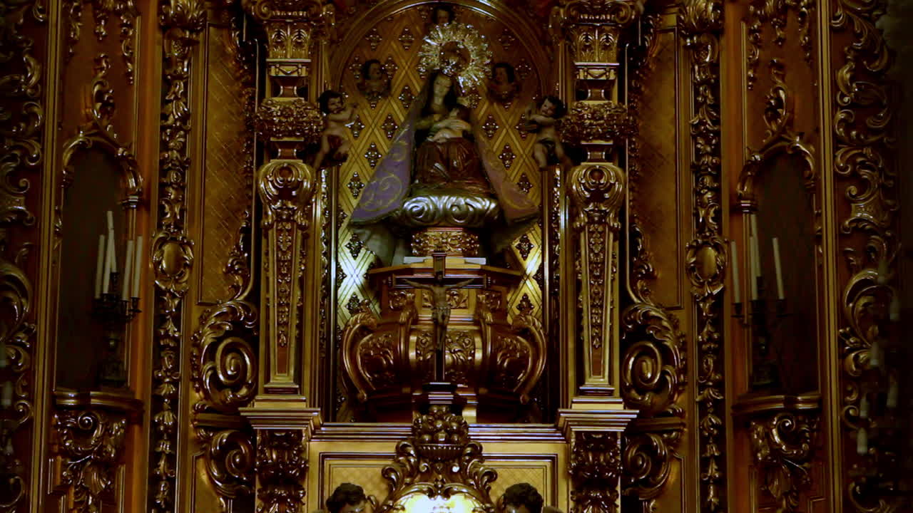 Baroque gold altar with Virgin and Child surrounded by angels inside a richly decorated Catholic church. Ornate, sacred, and timeless.