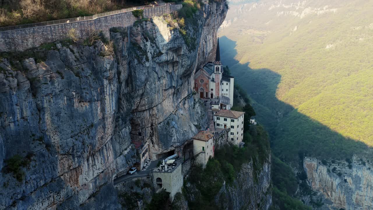 Slow aerial orbit of Church on cliff, Santuario Madonna della Corona, Italy