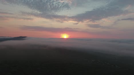 amazing drone shot above scrublands and clouds  during sunrise. location france