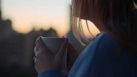 Woman-having-hot-morning-tea-outdoors