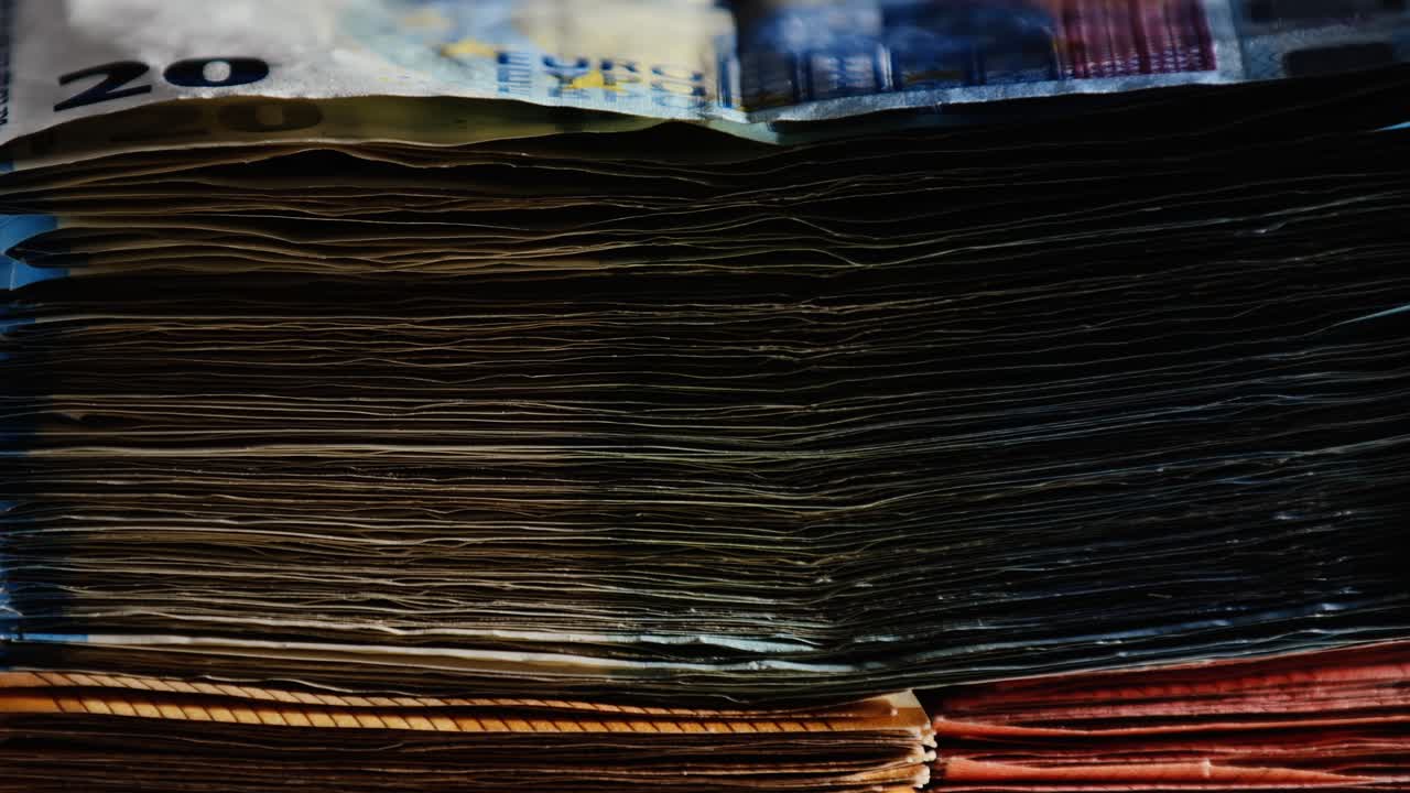 Macro 20 euro bill stack slowly spinning with denomination contrast on platform