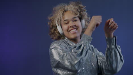 young woman dancing with headphones