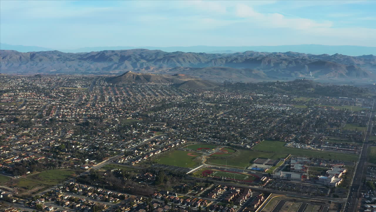 Aerial Drone shot of the city of Elsinore surrounded by the mountain range, California, USA