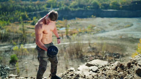 Athletic sportsman weightlifting. Handsome muscular shirtless man lifting dumbbells
